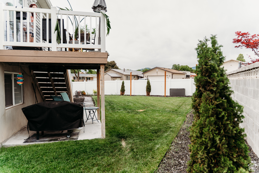 View of yard with stairway, a patio area, and a wooden deck