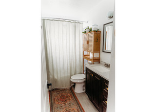 Full bath with vanity, wood finished floors, toilet, and shower / bathtub combination with curtain