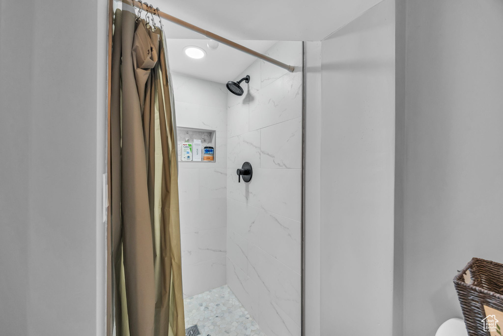 Bathroom featuring a stall shower and toilet