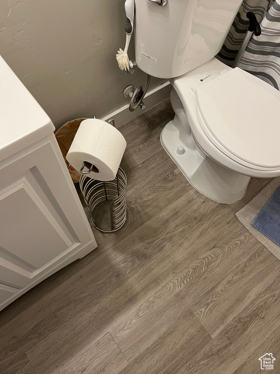 Bathroom featuring wood finished floors and toilet