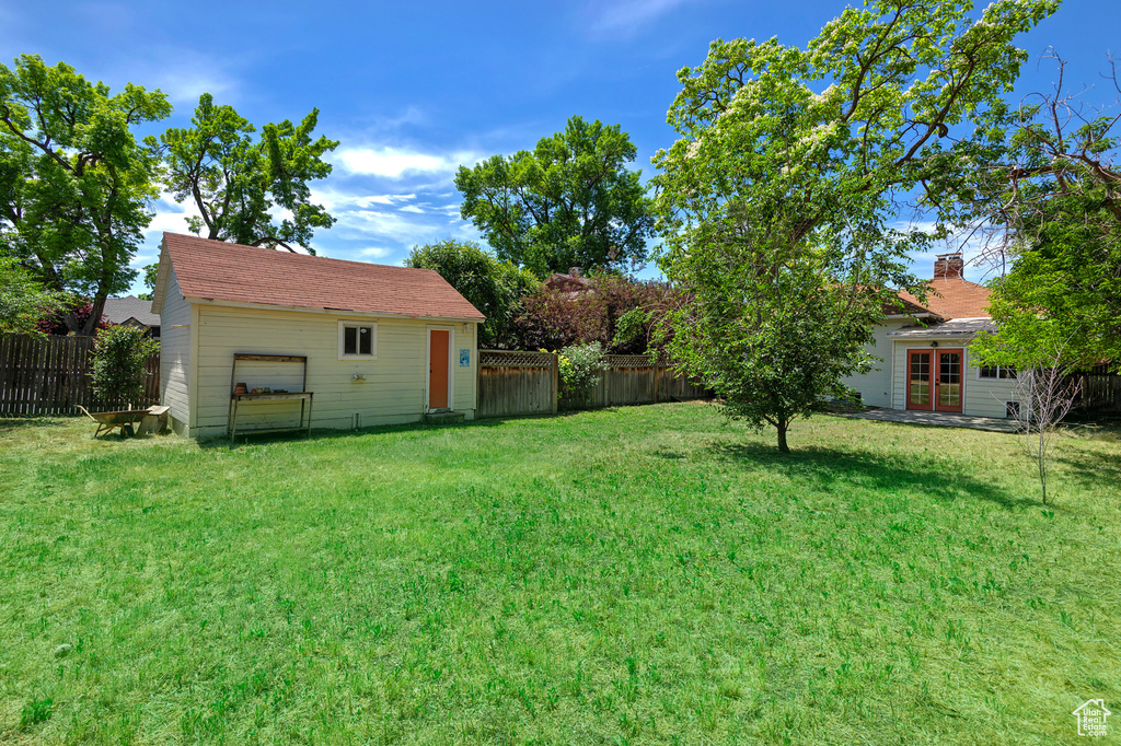 View of yard with french doors and an outdoor structure