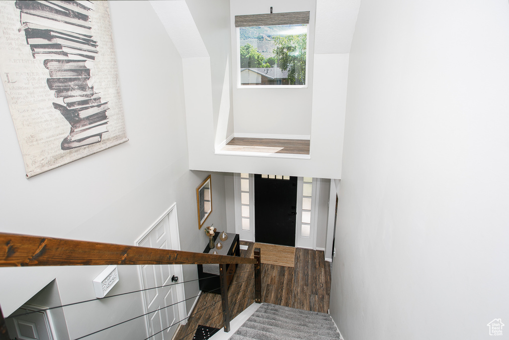 Entryway with a towering ceiling and baseboards