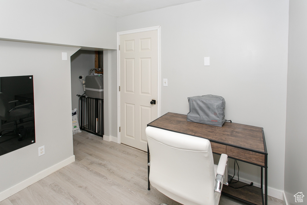 Home office featuring light wood-style floors and baseboards