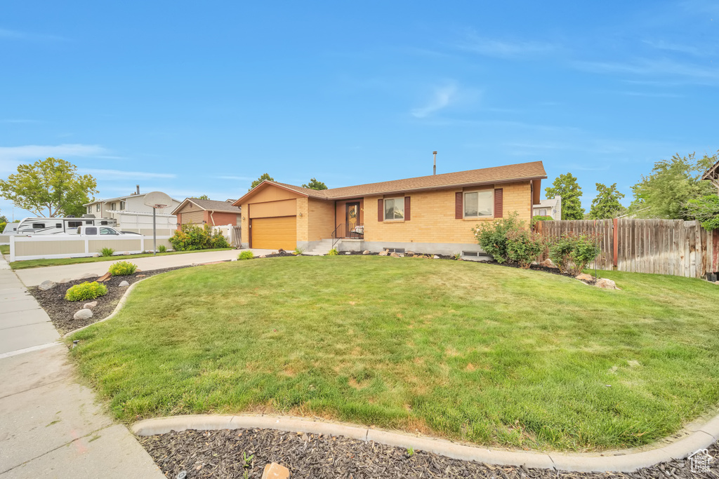 View of front of home with brick siding, an attached garage, and concrete driveway