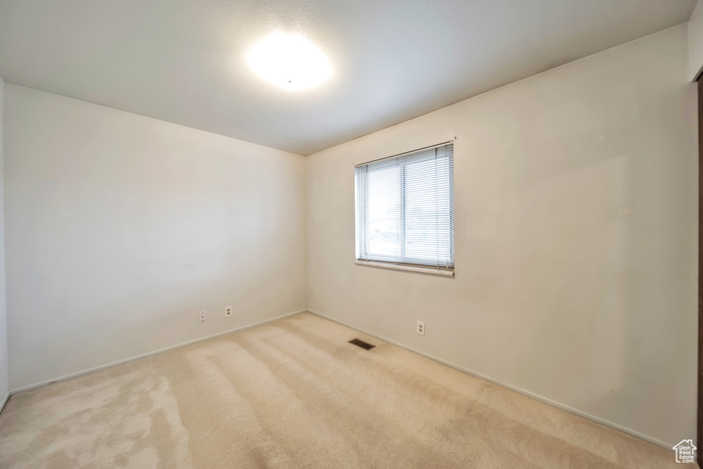 Unfurnished room with carpet and baseboards