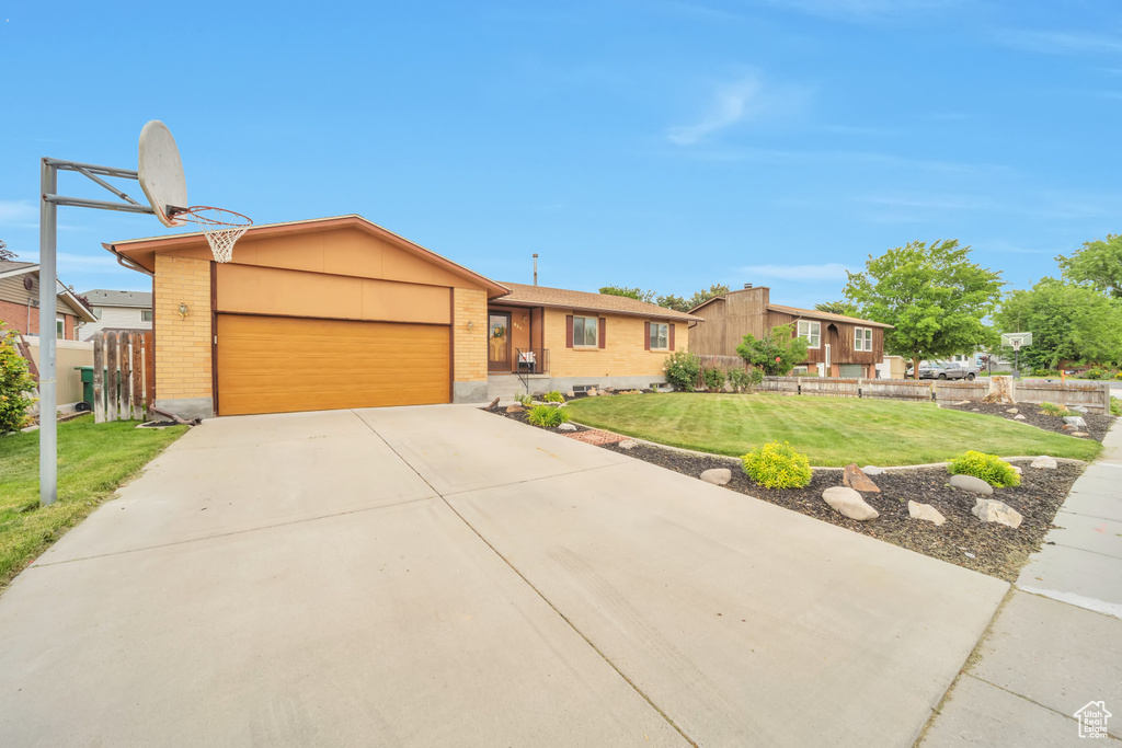 View of front of house featuring brick siding, a garage, and concrete driveway