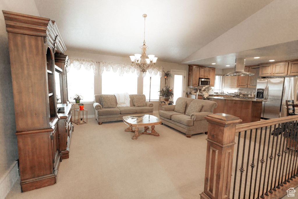 Living room featuring light carpet, a chandelier, and vaulted ceiling