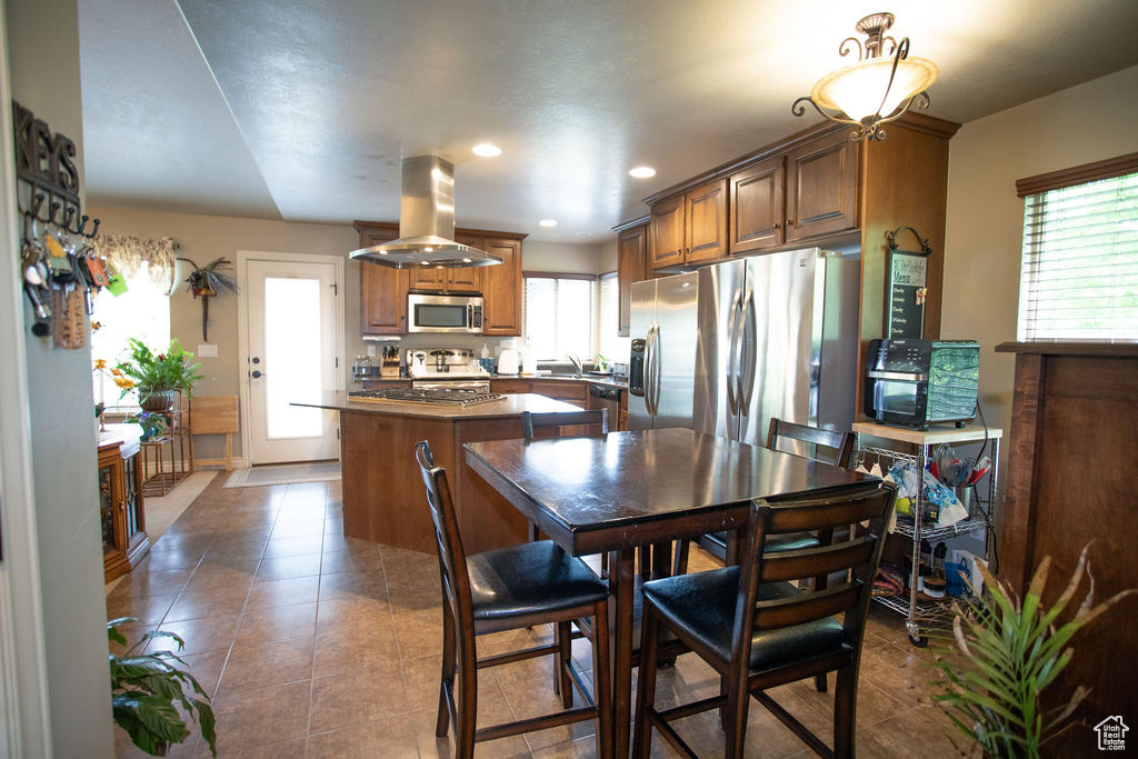 Dining space with tile patterned flooring and recessed lighting