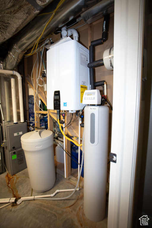 Utility room featuring tankless water heater