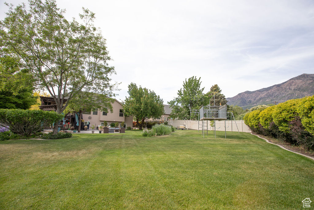 View of yard with a mountain view and a patio