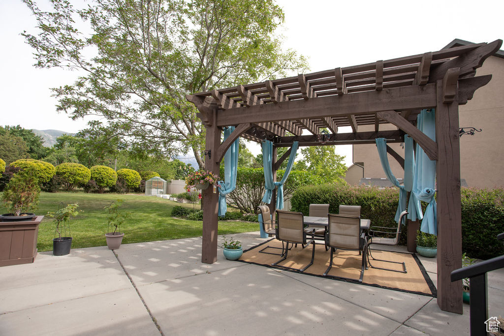 View of patio with a pergola and outdoor dining space