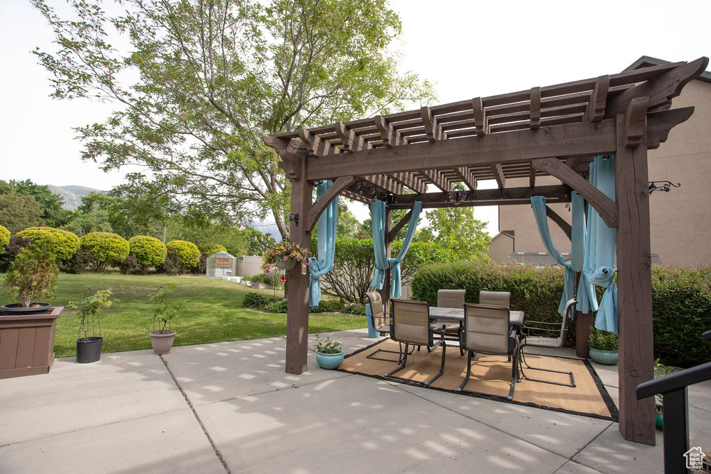 View of patio featuring a pergola and outdoor dining area