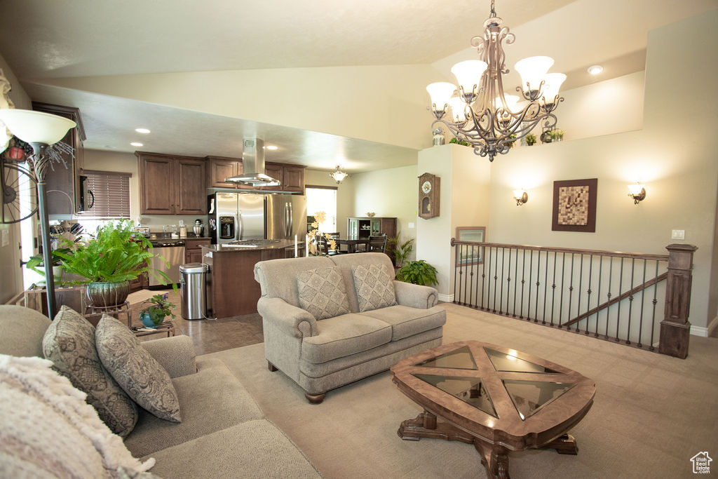 Living room featuring a chandelier, high vaulted ceiling, and recessed lighting