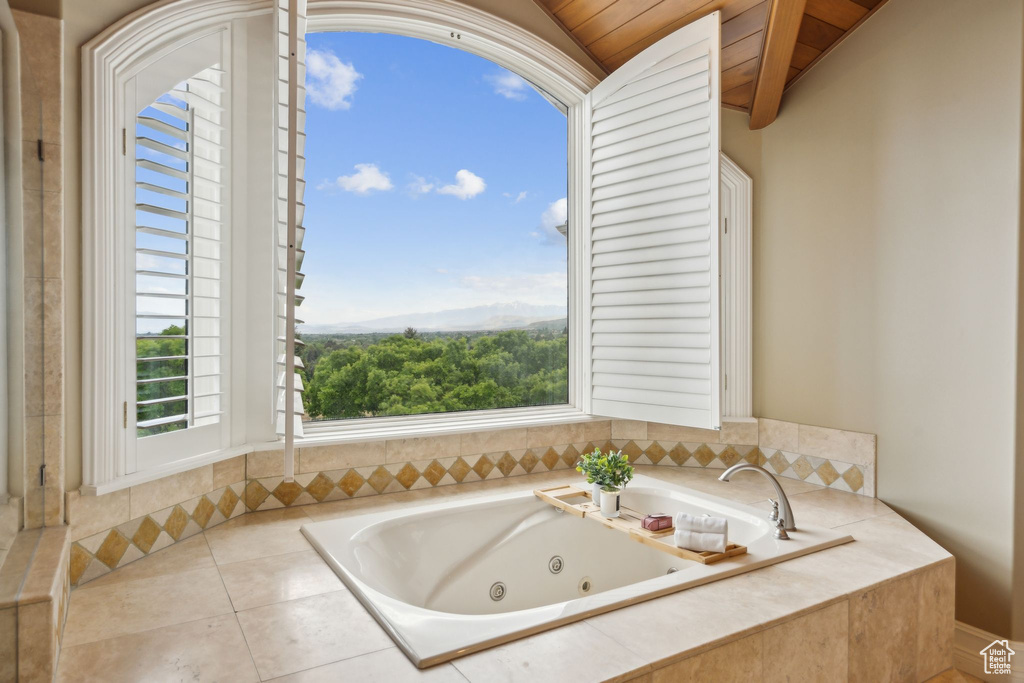 Bathroom with a jetted tub and lofted ceiling