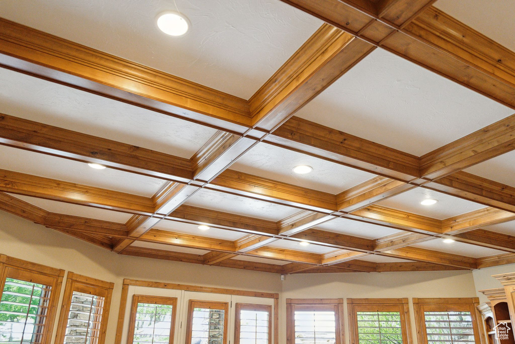 Detailed view of coffered ceiling, beam ceiling, recessed lighting, and french doors