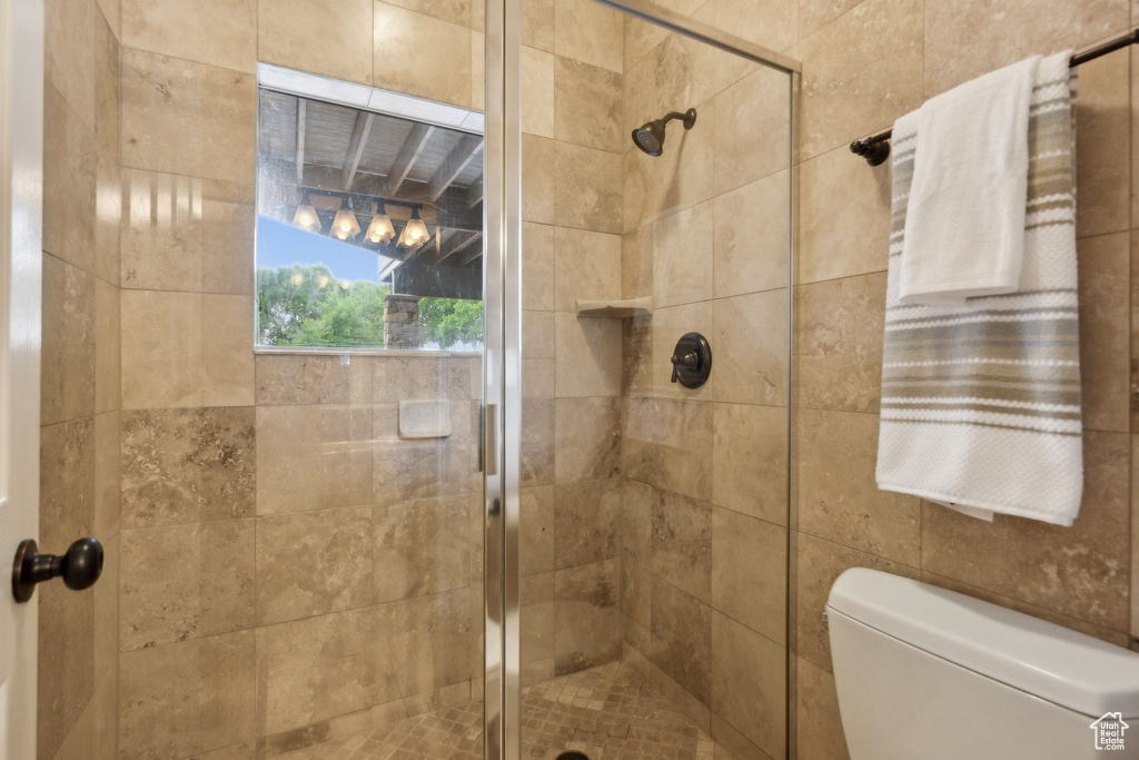 Bathroom with a stall shower and toilet