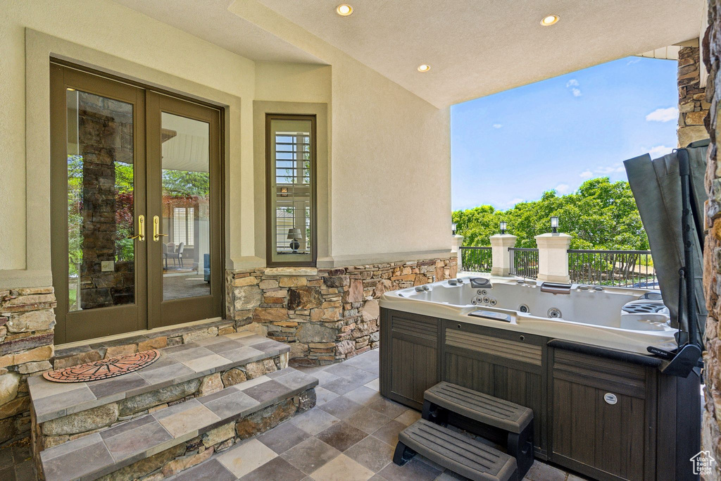 View of patio featuring french doors and a hot tub