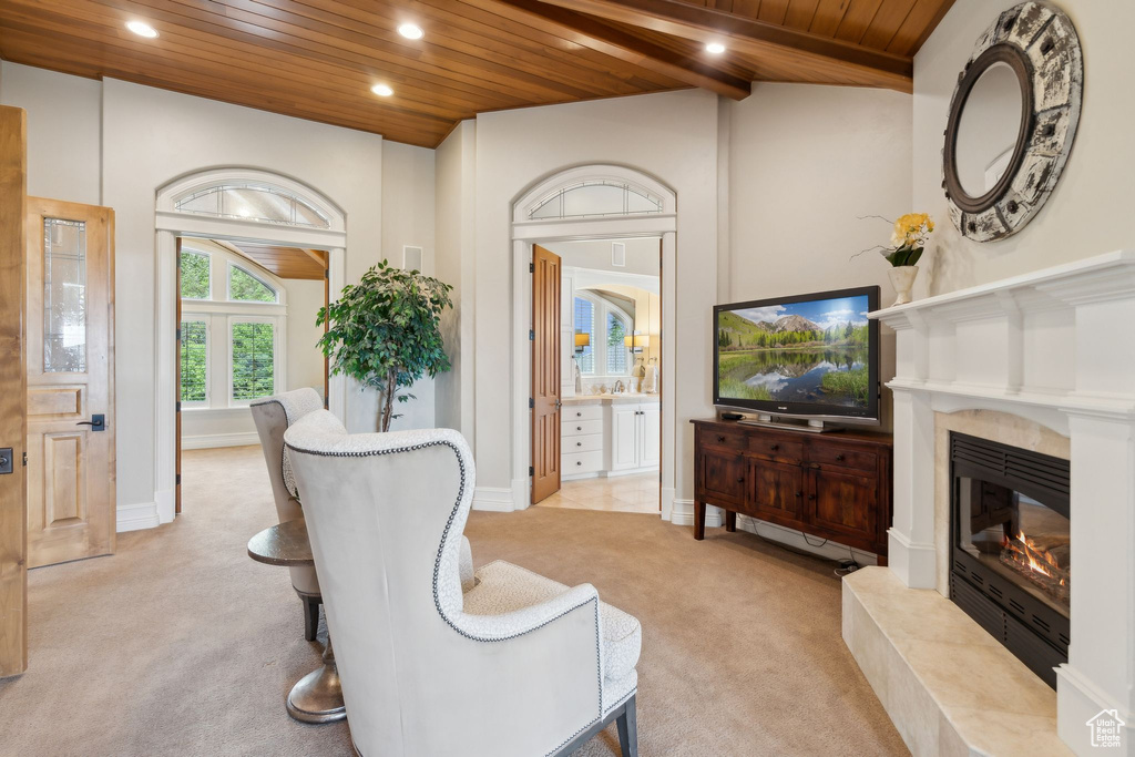Living room with wooden ceiling, light carpet, a fireplace, recessed lighting, and baseboards