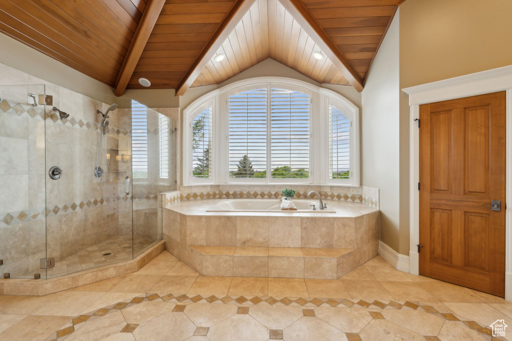 Full bathroom featuring wood ceiling, a garden tub, tile patterned flooring, and inlaid floor details