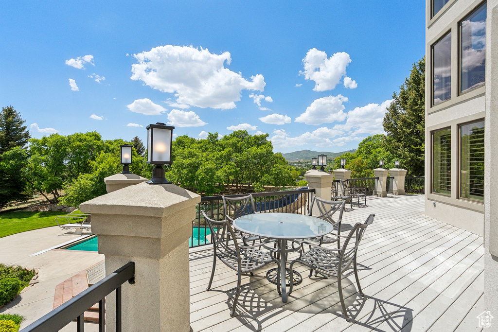 Wooden terrace featuring outdoor dining area