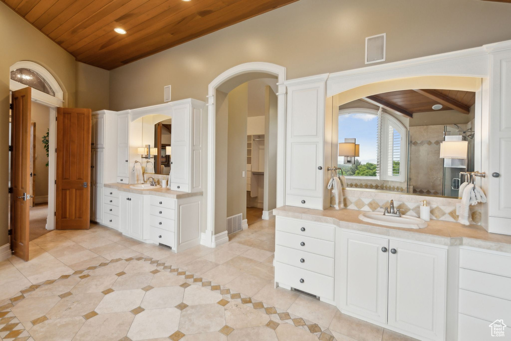 Bathroom featuring wood ceiling, two vanities, tile patterned flooring, recessed lighting, and baseboards