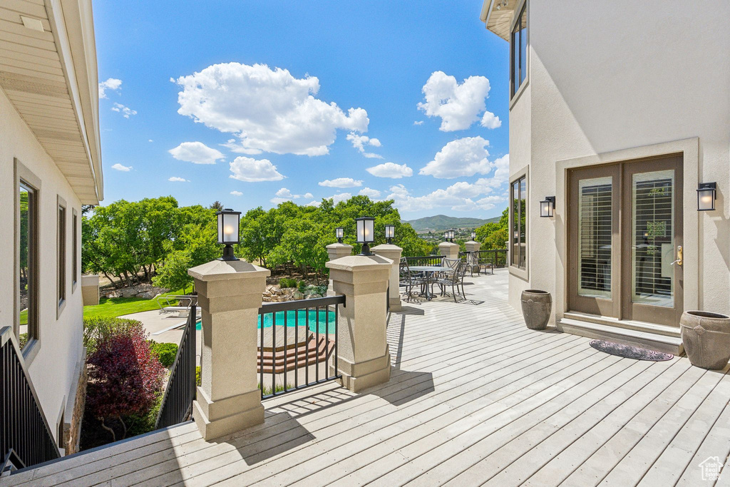 Deck featuring outdoor dining space and a mountain view