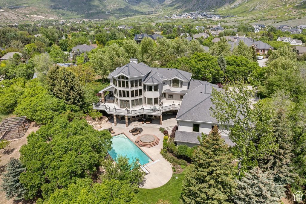 View of subject property featuring a pool and mountains