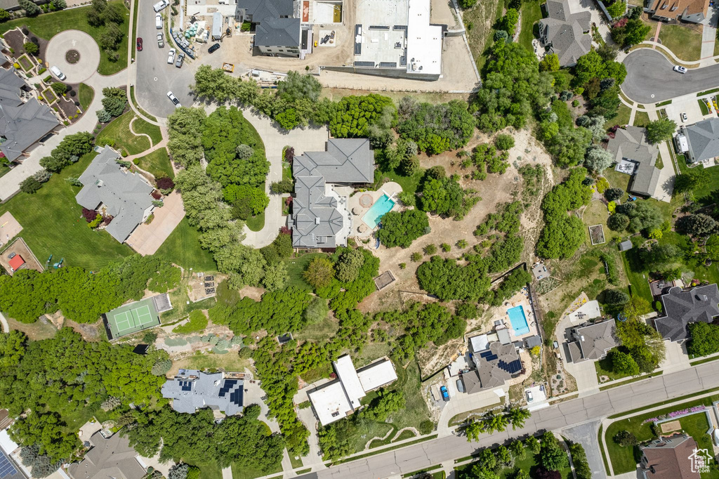 Aerial view of property and surrounding area with nearby suburban area