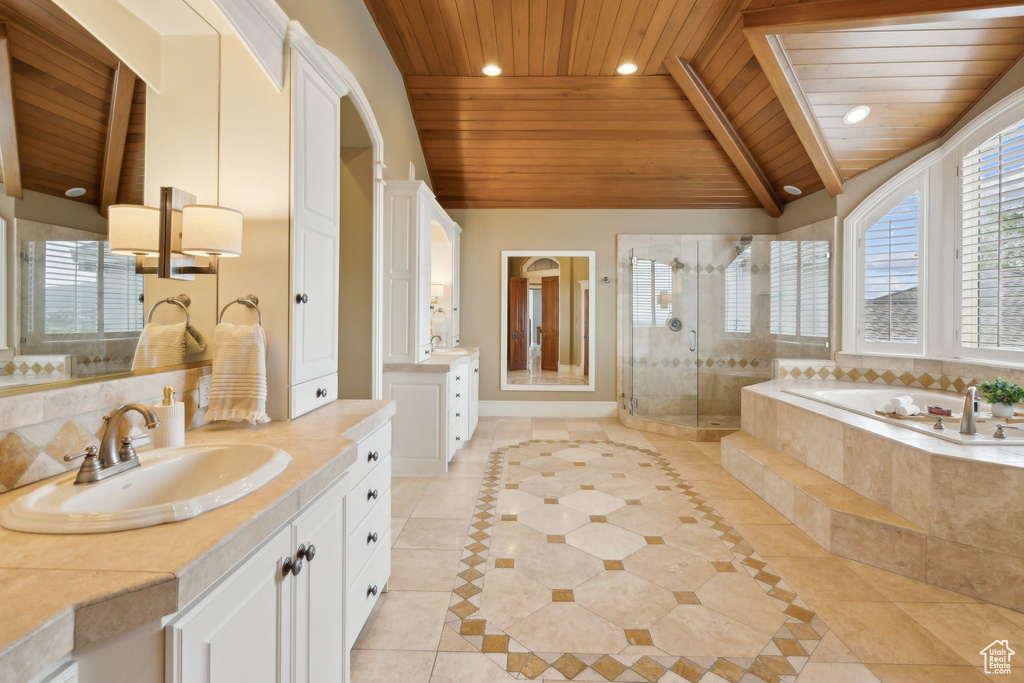 Full bath featuring wooden ceiling, tile patterned floors, two vanities, a stall shower, and a bath