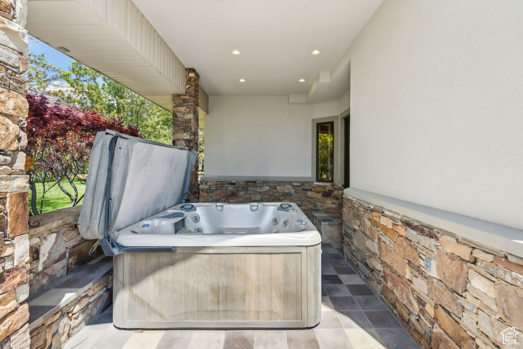 View of patio / terrace featuring a hot tub and washer / clothes dryer