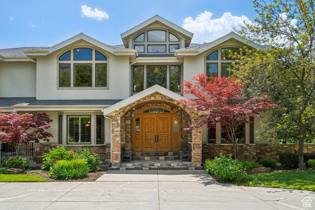 Property entrance with stucco siding and stone siding