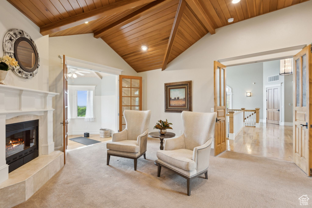 Living area with wood ceiling, carpet, a premium fireplace, ceiling fan, and recessed lighting