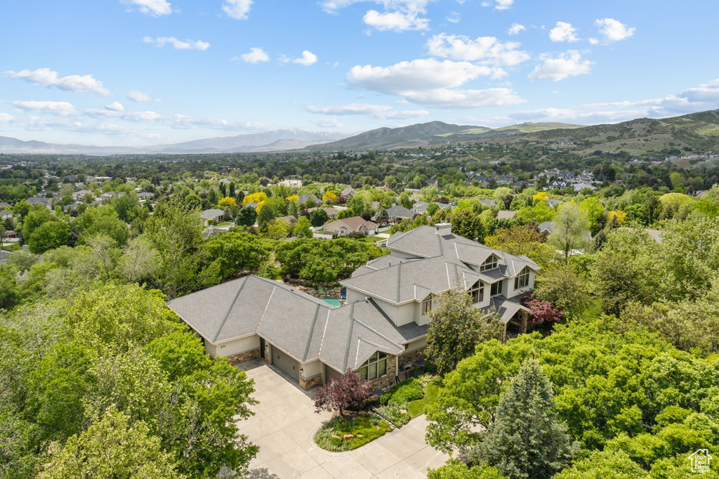 Aerial view of property and surrounding area featuring mountains