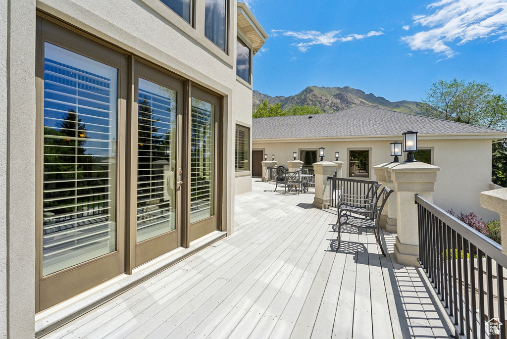 Deck featuring a mountain view and outdoor dining area