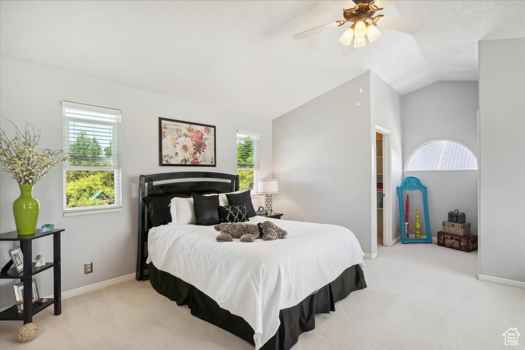 Bedroom featuring carpet flooring, vaulted ceiling, baseboards, and ceiling fan