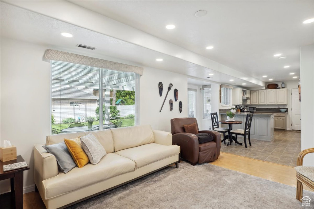 Living area with recessed lighting and light wood-style flooring