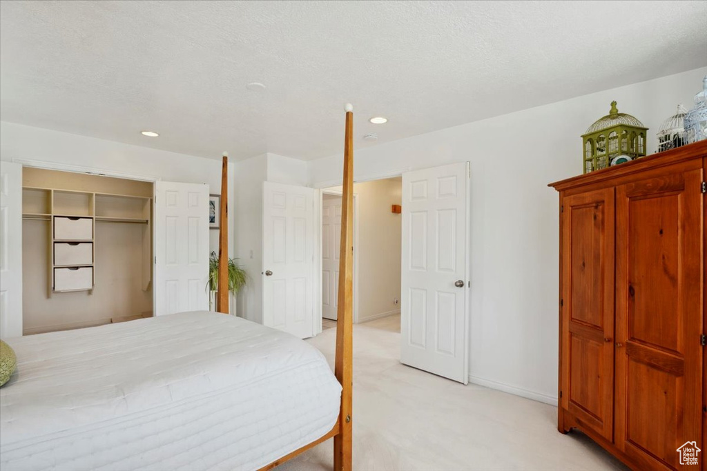Bedroom featuring light colored carpet, recessed lighting, and baseboards