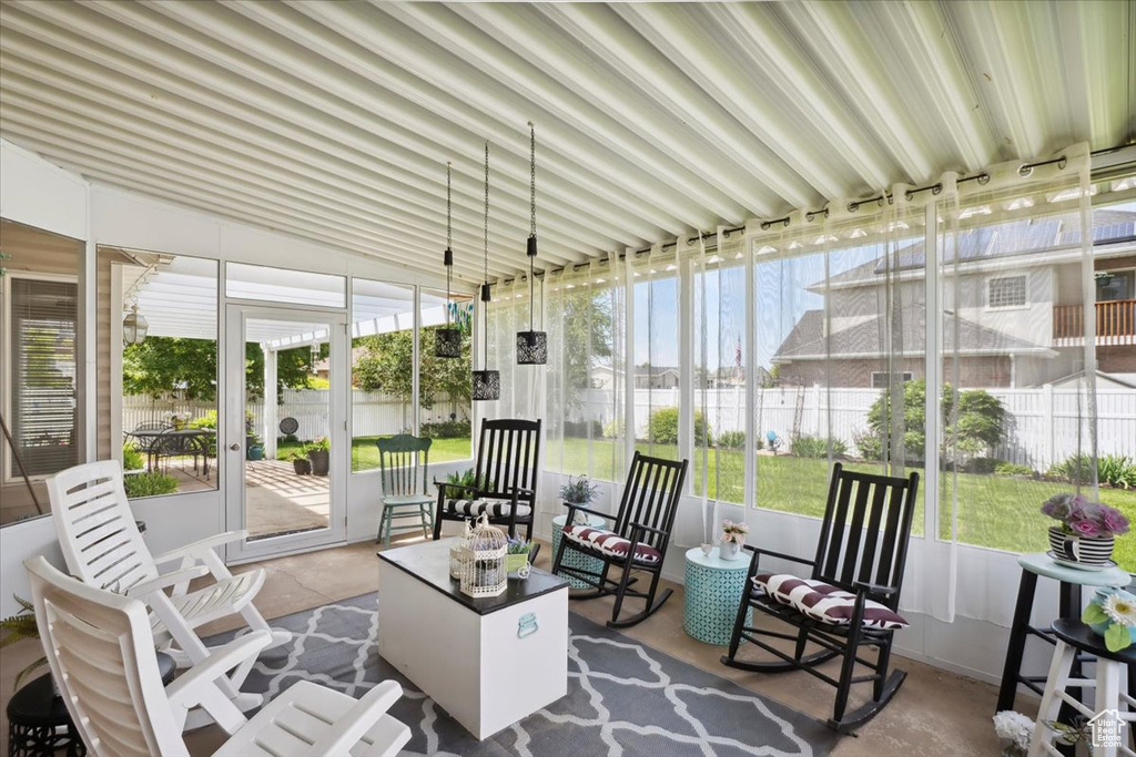 Sunroom featuring vaulted ceiling and an outdoor living space