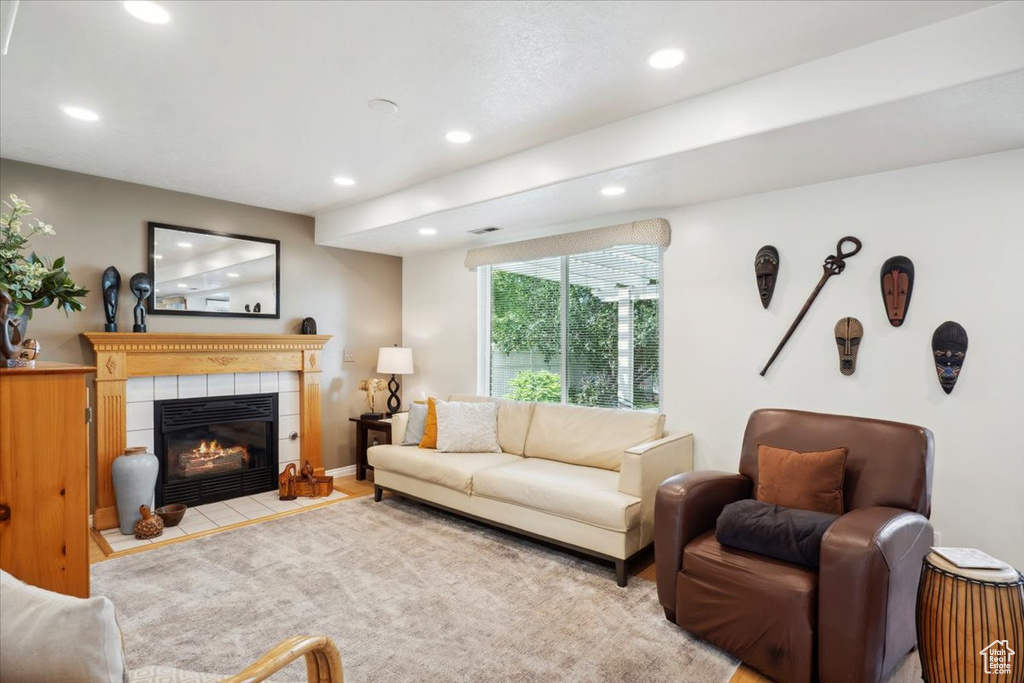 Living room featuring recessed lighting and a tile fireplace