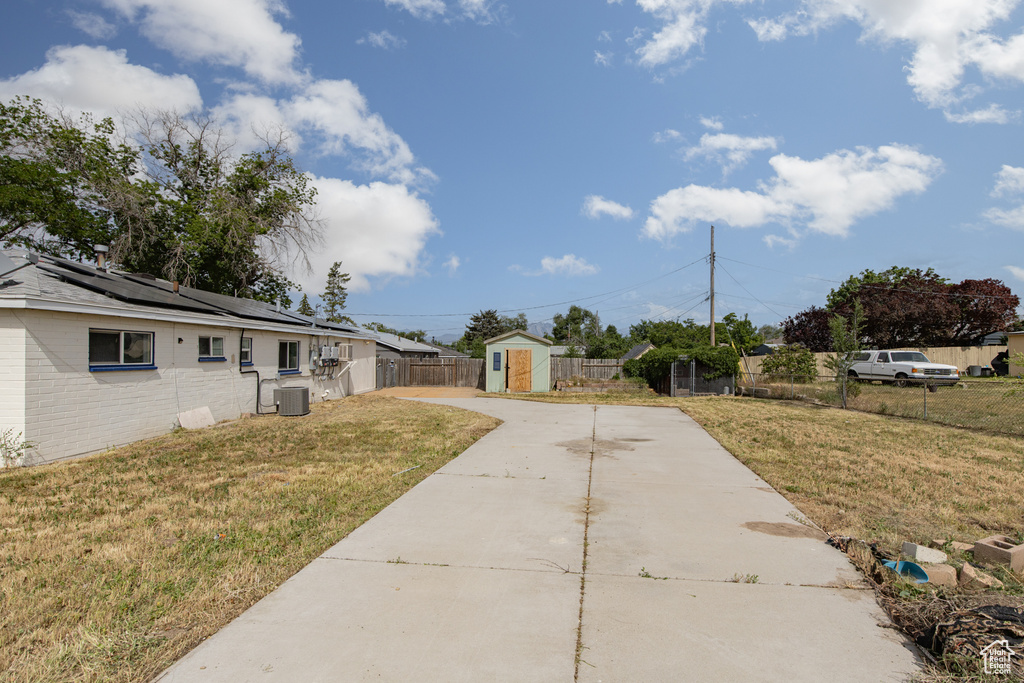 View of yard featuring driveway and central AC
