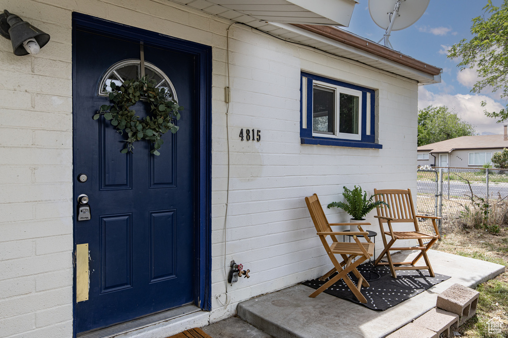 View of exterior entry featuring concrete block siding