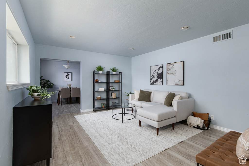 Living area with light wood-type flooring and baseboards