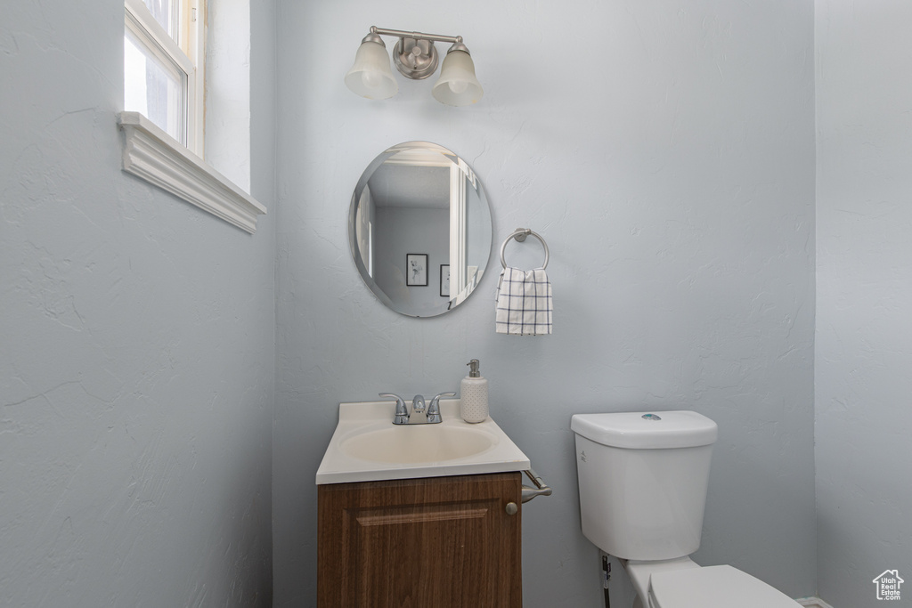 Half bathroom featuring toilet and vanity
