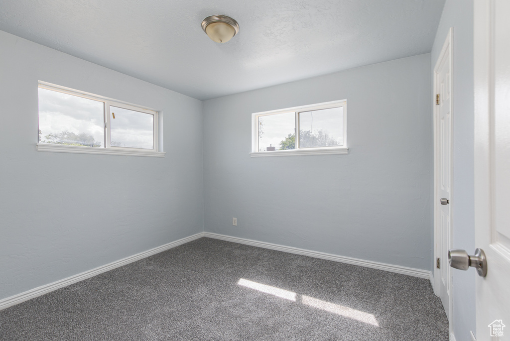 Spare room with carpet floors and baseboards