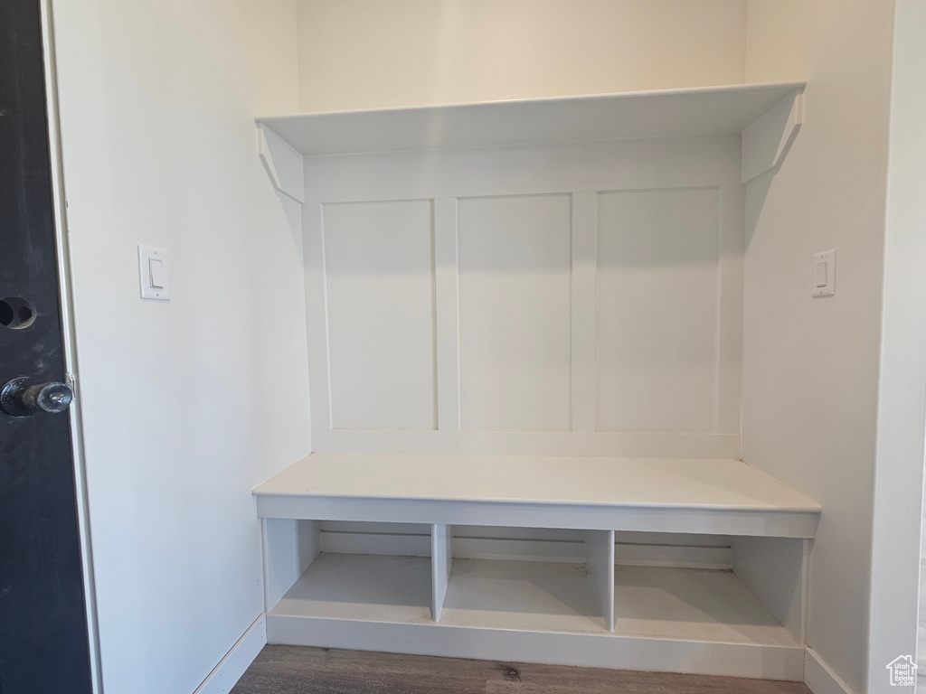 Mudroom with baseboards and wood finished floors