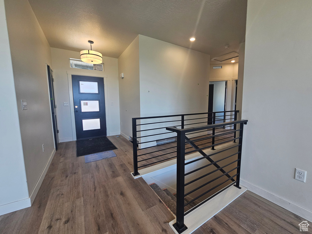 Foyer entrance featuring wood finished floors and baseboards