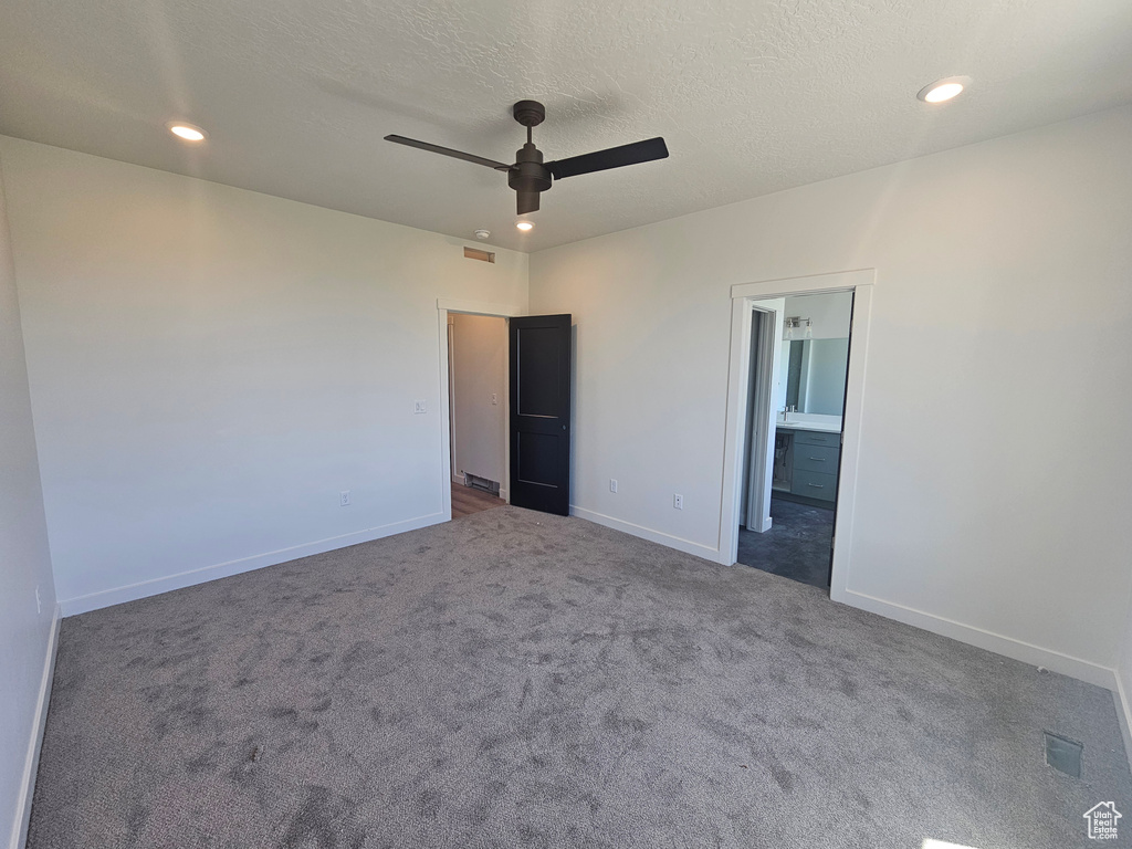 Unfurnished bedroom featuring carpet, baseboards, recessed lighting, ensuite bath, and ceiling fan