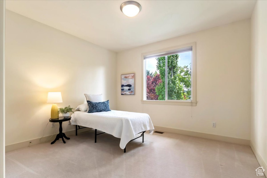 Carpeted bedroom featuring baseboards