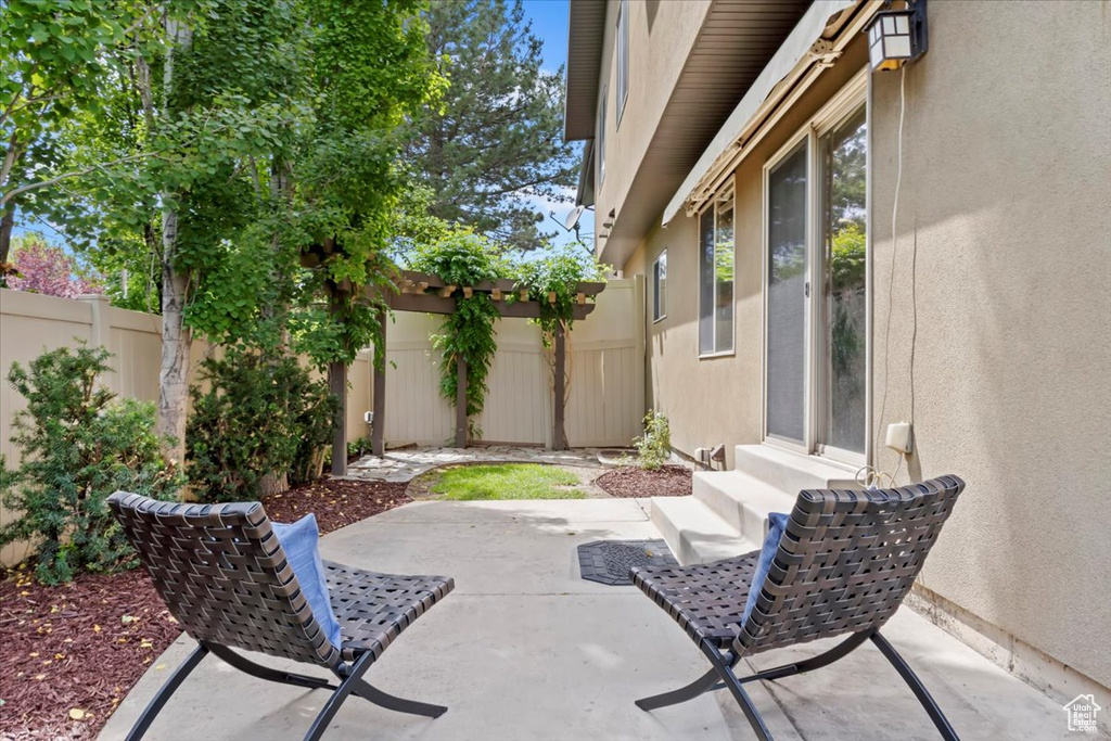 Fenced backyard with a patio area and entry steps