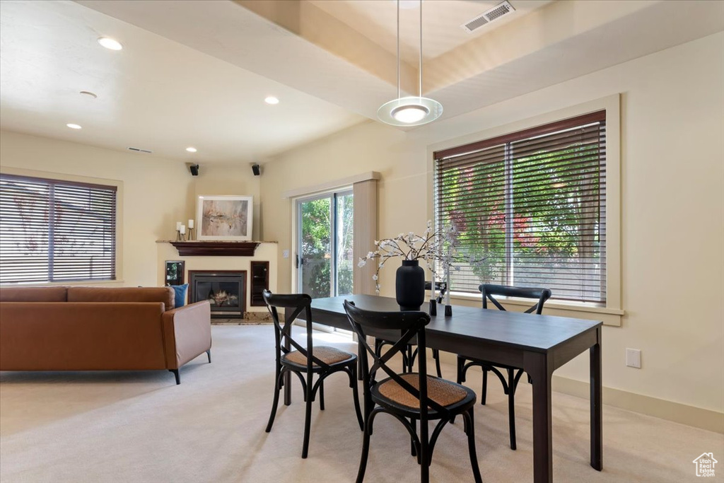 Dining area with light colored carpet, a fireplace, recessed lighting, and baseboards